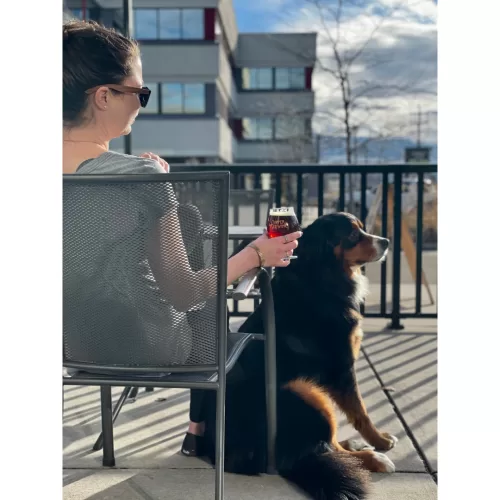 Dog and girl holding beer at Copper Brewing Co