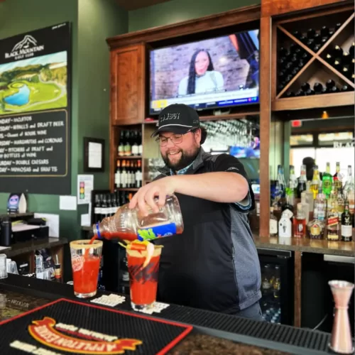 Bartender pouring caesars at the Grill at Black Mountain